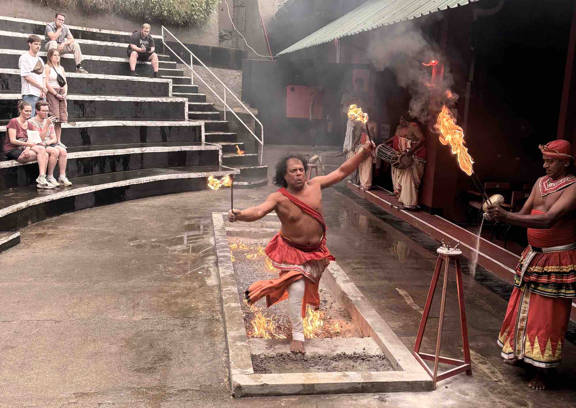 Close-up of fire walking performer with traditional white sarong at the Kandy Cultural Show