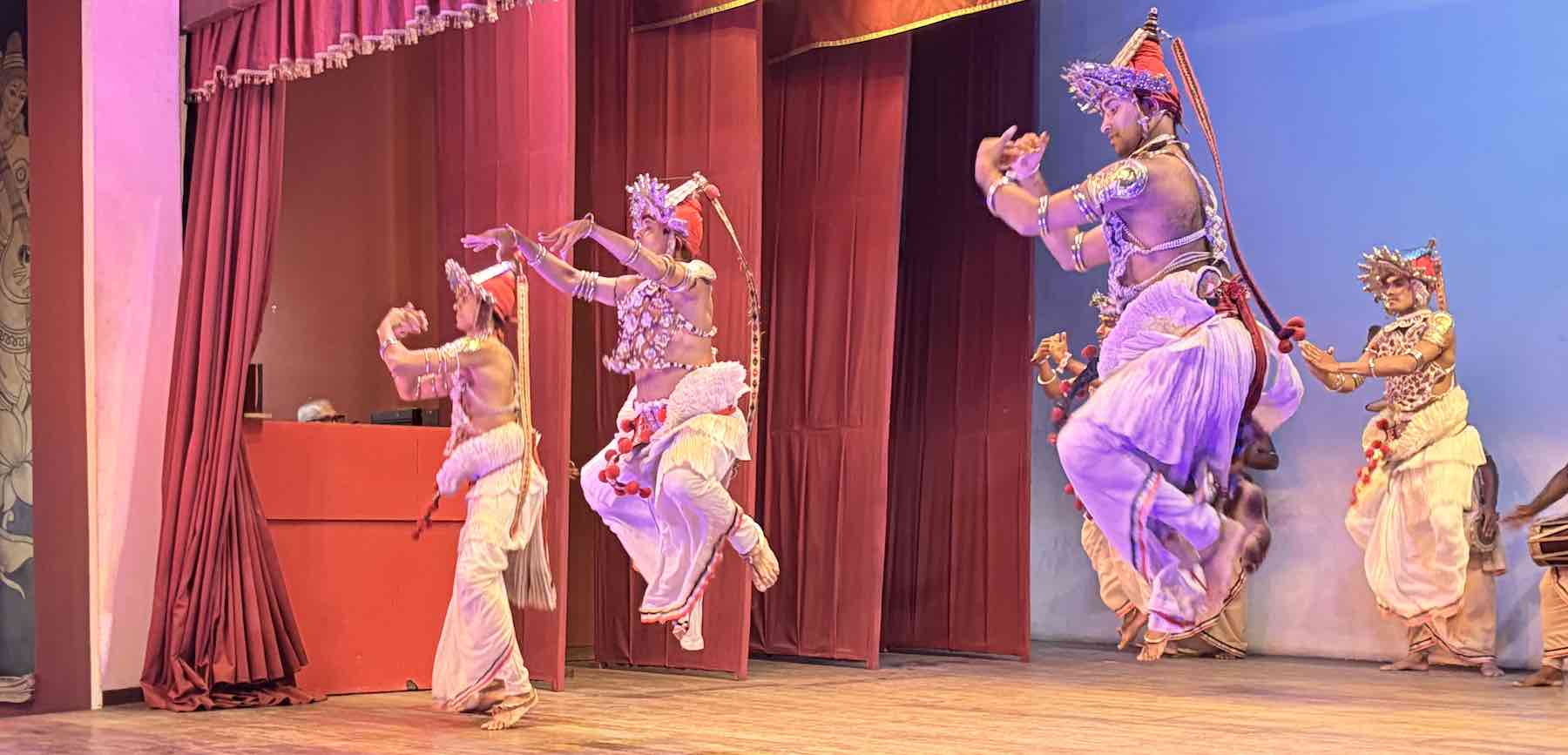 Kandyan dancer performing the Pantheru Natum tambourine dance at a Kandy cultural show