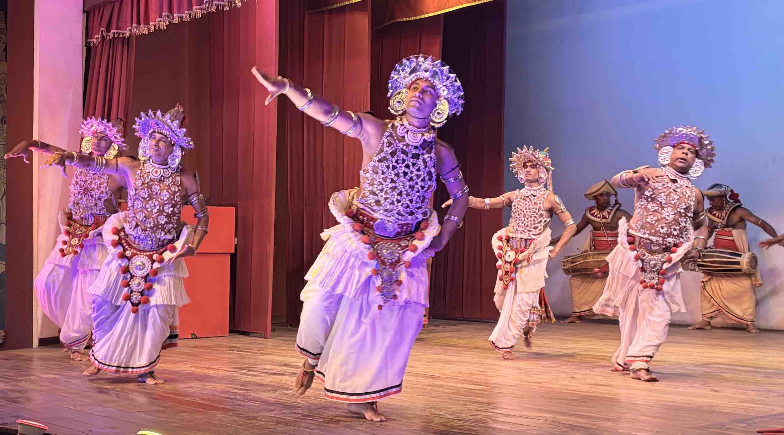 Kandyan dancer performing the Raksha mask dance with a colourful Cobra Naga Raksha mask